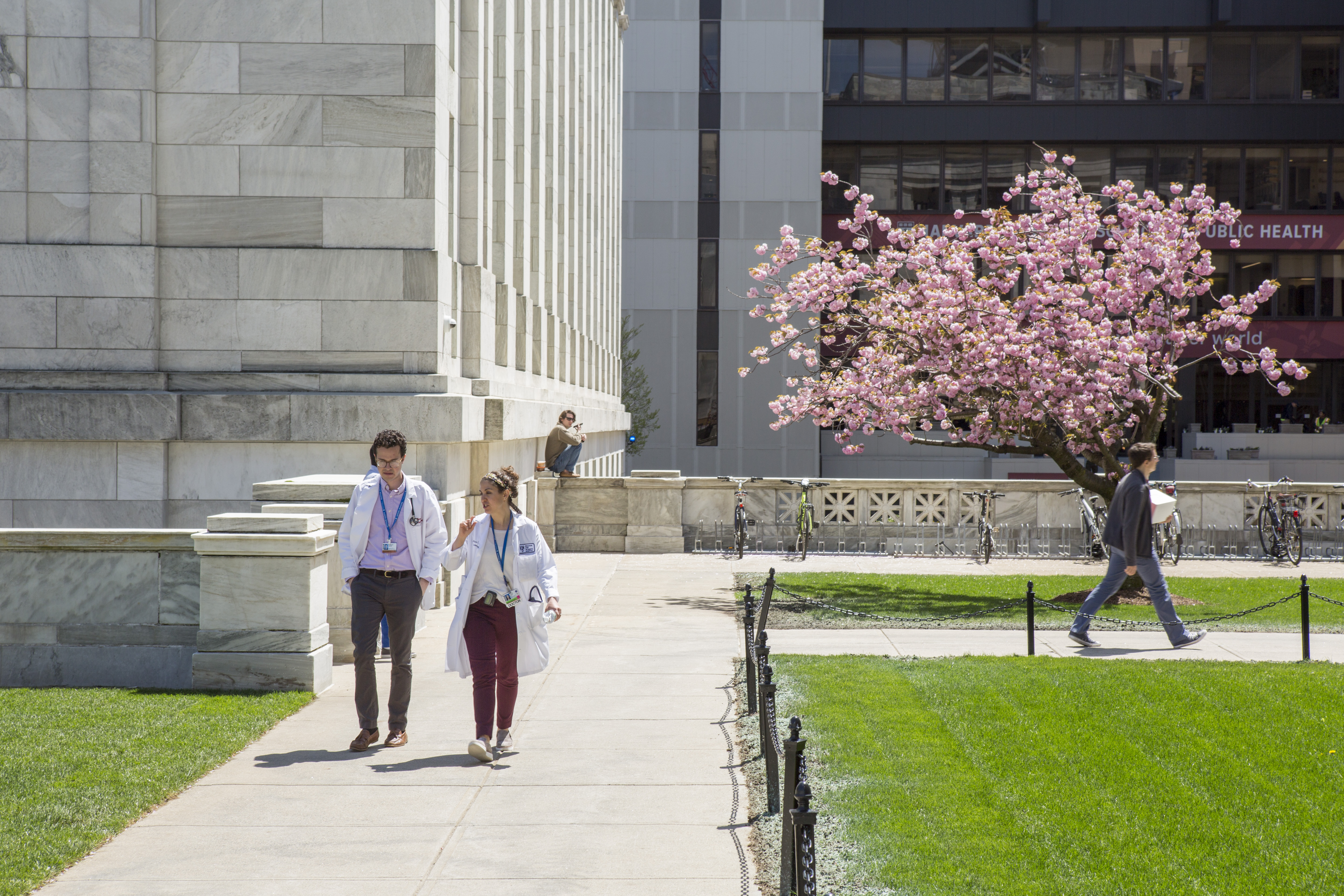 Two medical students walking on the quad.