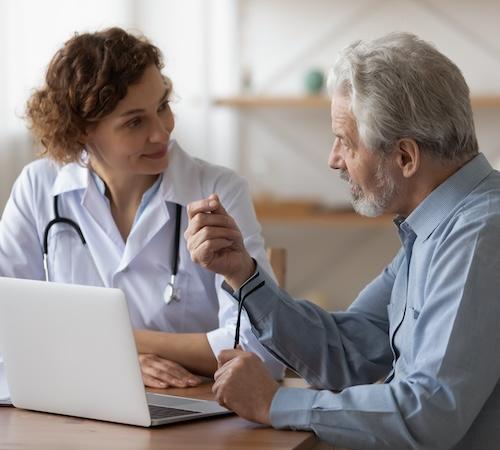 A health care provider and a patient talking.