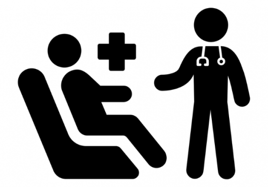 Basic icon of a Doctor speaking to a patient on a hospital bed